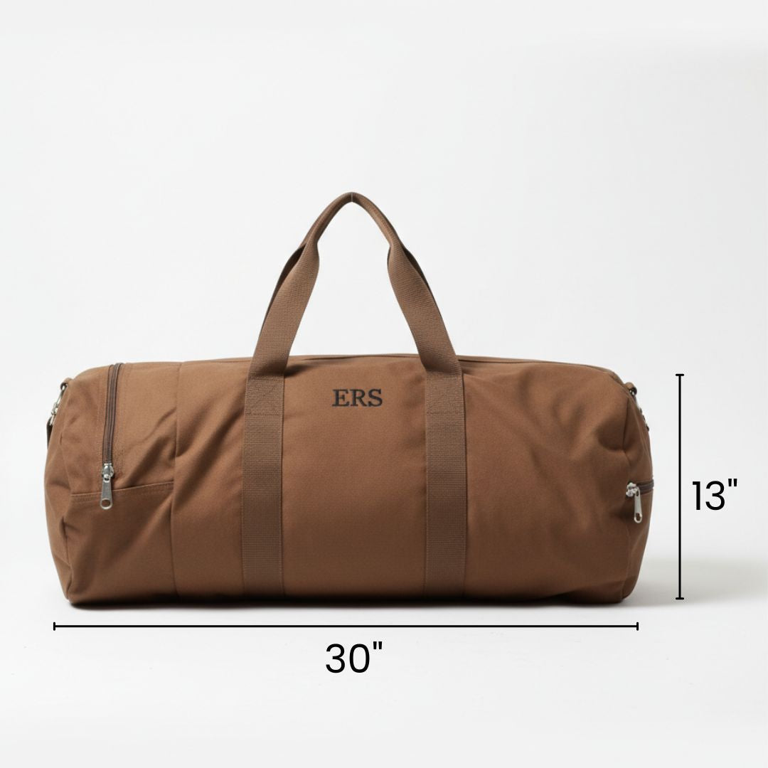 Tan canvas duffle bag with sample personalization "ERS" embroidered on front, shown with dimensions of 30 inches by 13 inches