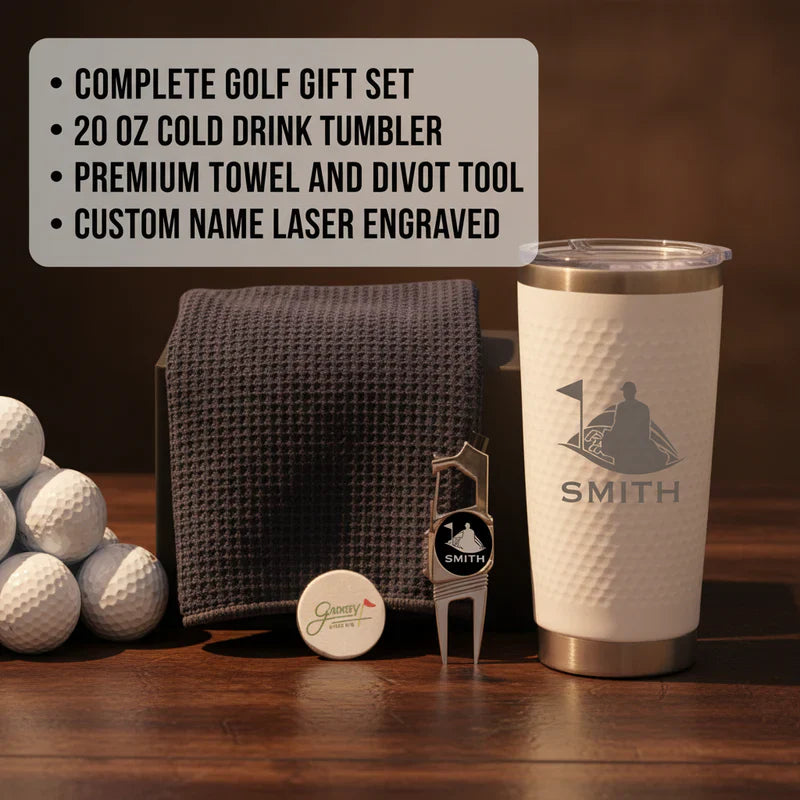 Golf gift set including 20 oz tumbler engraved with sample name "Smith," gray towel, divot tool, and golf balls on wooden surface.