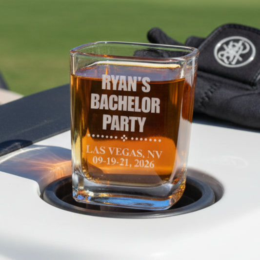 Personalized glass with 'Ryan's Bachelor Party' text on a car cup holder with a blurred background