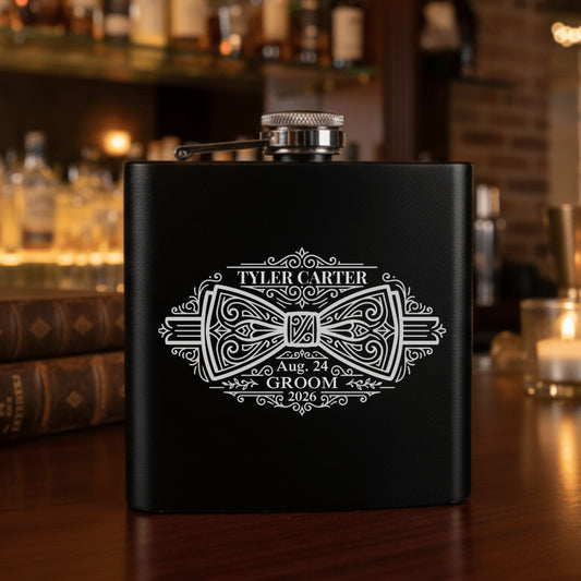 Black flask with white engraving on a bar counter