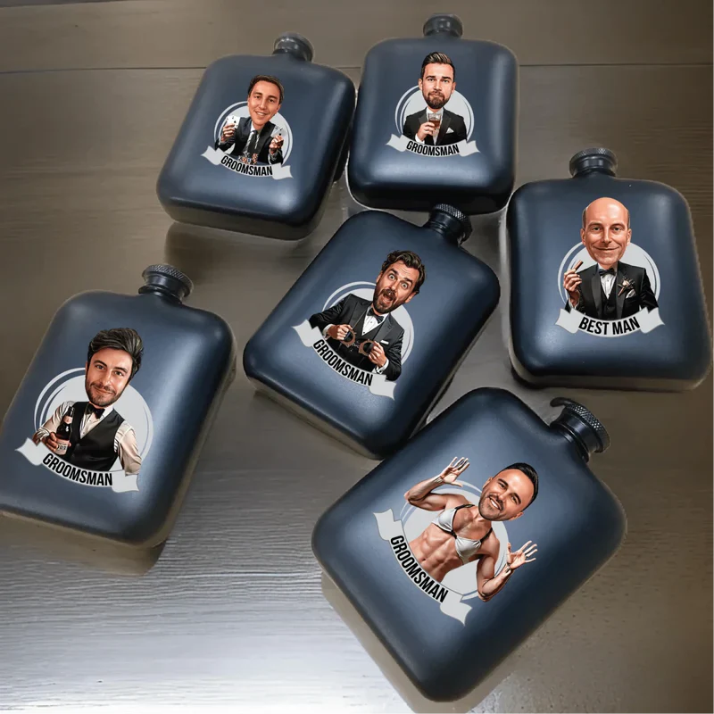 Six navy stainless steel flasks with custom cartoon caricatures and "Groomsman" and "Best Man" labels showing personalized sample engravings.