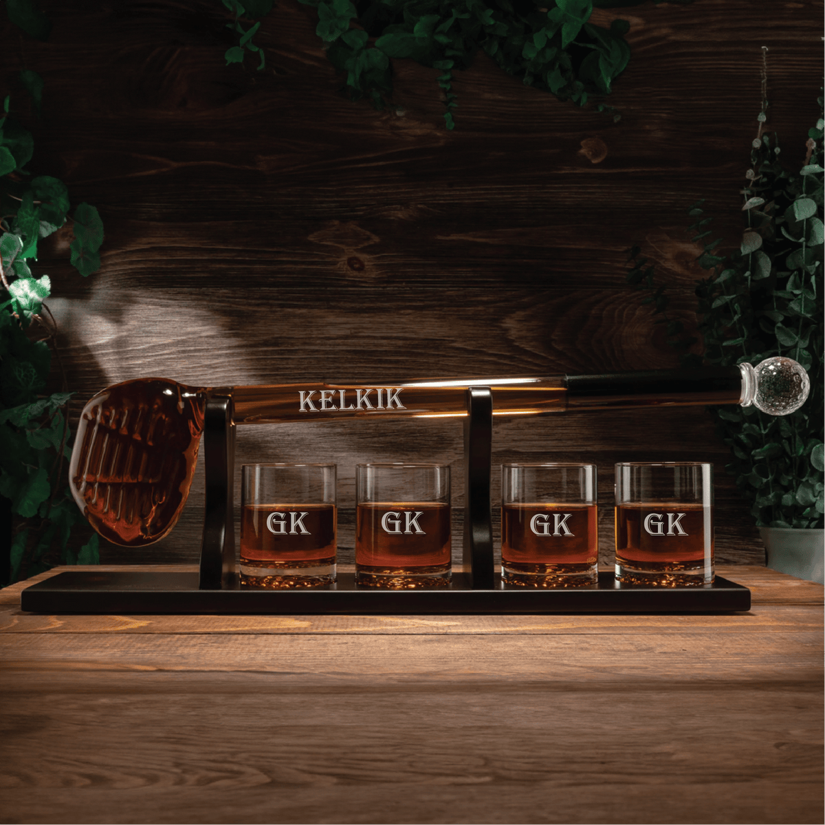 Golf club-shaped whiskey decanter set with four glasses on mahogany base; perfect gift for golf lovers.