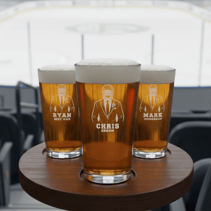Three pints of beer on a wooden coaster with engraved names and titles.