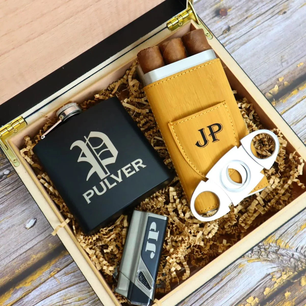 Gift set with black flask, leather case, and cutter in a wooden box.