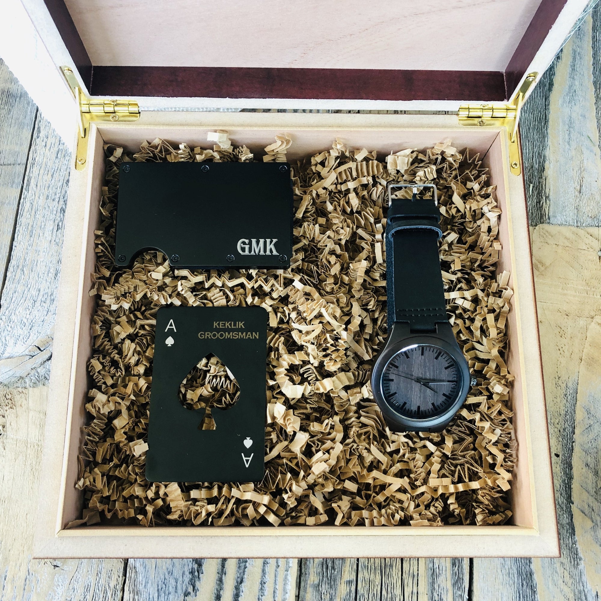 Gift set including engraved credit card holder, bottle opener, and watch