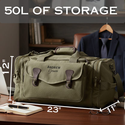 Olive canvas duffle bag with brown leather handles and accents, personalized with sample text "ANDREW Groom" on the front, displayed on wooden desk with dimensions marked showing 23" length and 12" height