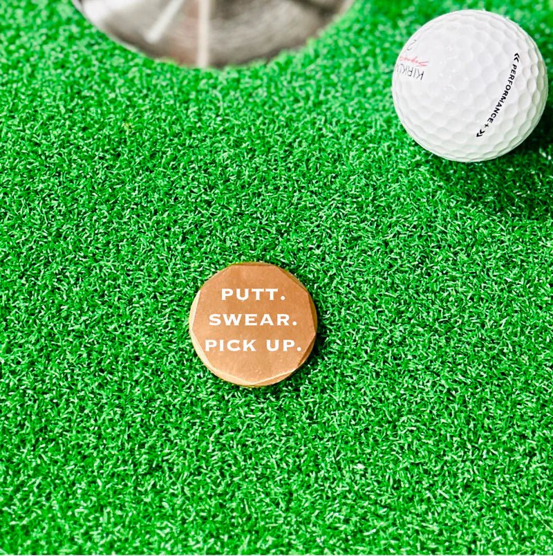 Copper golf ball marker with humorous design, lightweight and perfect for pocket carry