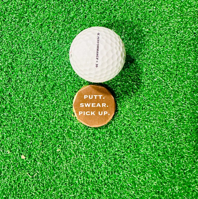 Copper golf ball marker with humorous design, lightweight and perfect for pocket carry