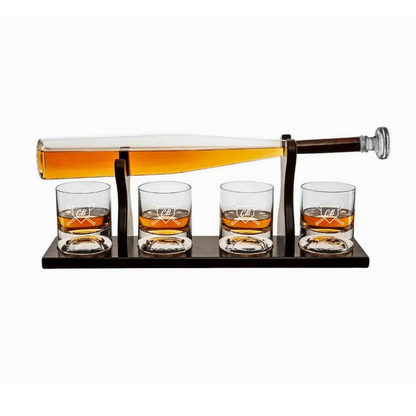 Engraved baseball bat decanter set with amber liquor in tilting bottle and four matching glasses with sample initials on black stand