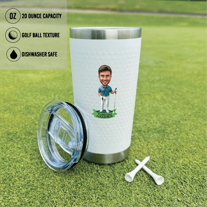 White 20-ounce golf tumbler with stainless steel base and clear lid, featuring sample personalized caricature illustration, displayed on synthetic grass with golf tees.