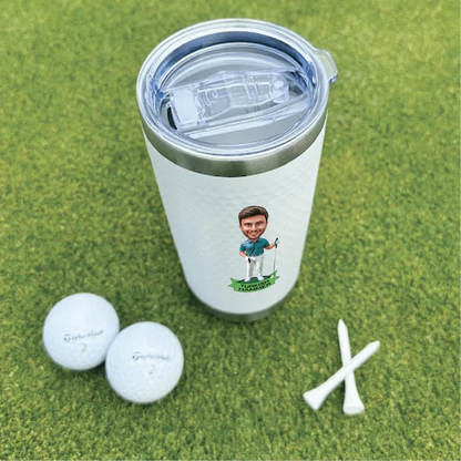 White insulated tumbler with sample golf-themed caricature personalization, displayed with golf balls and tees on green turf.