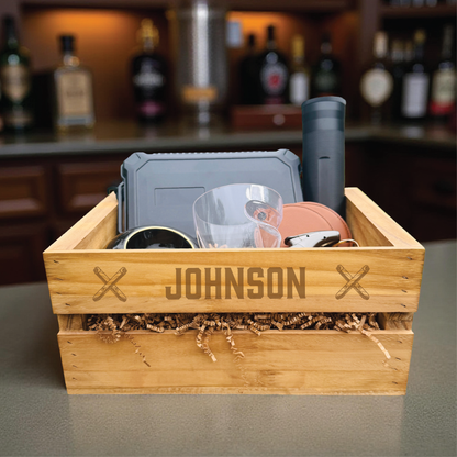 Personalized groomsmen cigar gift set in an engraved wooden crate with a cigar humidor and whiskey glass.