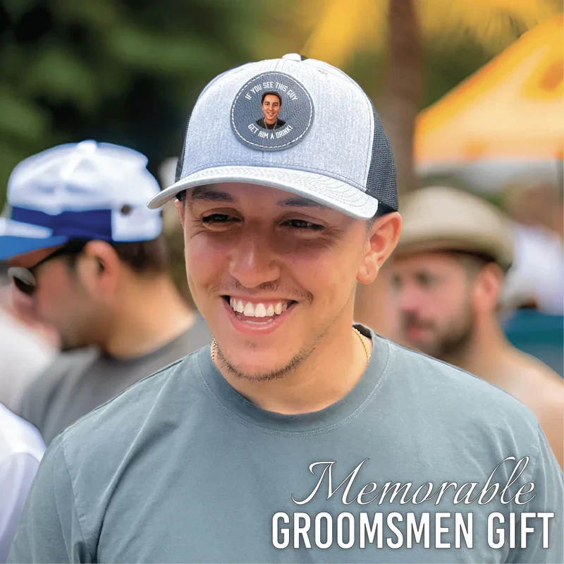Light gray and mesh trucker hat with circular patch featuring sample photo and personalization on the crown, worn at outdoor event.