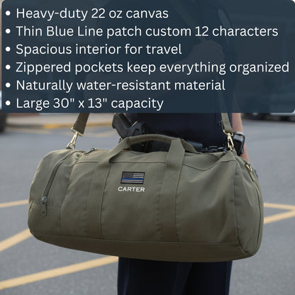 Olive canvas duffle bag with custom "CARTER" name and Thin Blue Line flag patch embroidered on front, held by person outdoors.