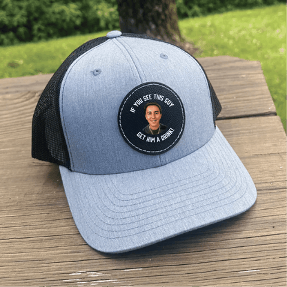 Light gray and black trucker cap with circular patch featuring photo sample and text "If you see this guy, get him a drink