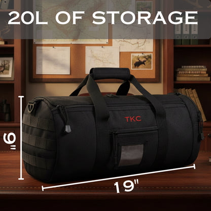 Black tactical duffle bag with sample "TKC" monogram, 19 inches wide and 16 inches tall, showing 20L storage capacity on wooden desk.