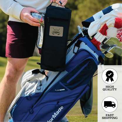 Person holding black insulated golf bag cooler with engraved anchor emblem, displayed next to blue golf bag on grass course.