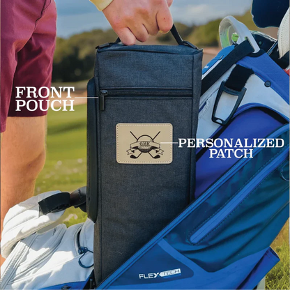 Dark blue golf bag cooler with front zipper pouch and sample personalized leather patch showing golf club initials, held outdoors on golf course
