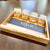 Personalized acacia wood serving tray set with slate insert and gold-rimmed whiskey glasses