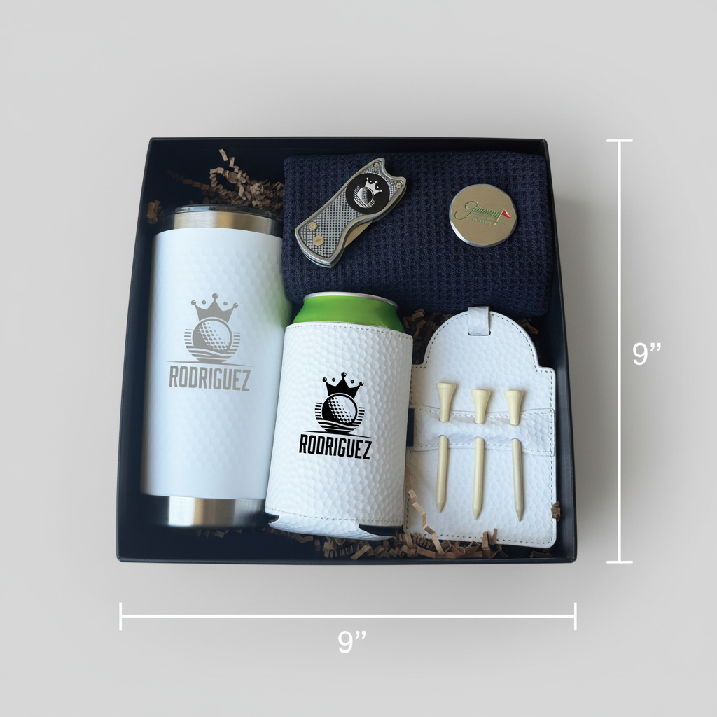 Black gift box containing engraved insulated tumbler, golf-themed can cooler, white golf towel with tees, cigar cutter, and round personalization sample labeled "Rodriguez