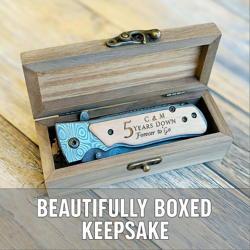 Engraved folding knife with blue and white handle inside wooden box, sample reads "C & M 5 Years Down Forever to Go