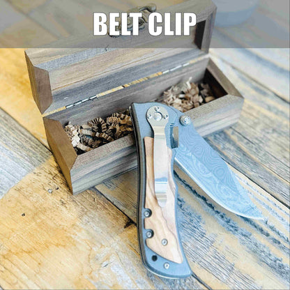 Folding knife with blue and tan handle displayed next to open wooden box containing packing material and shredded paper.